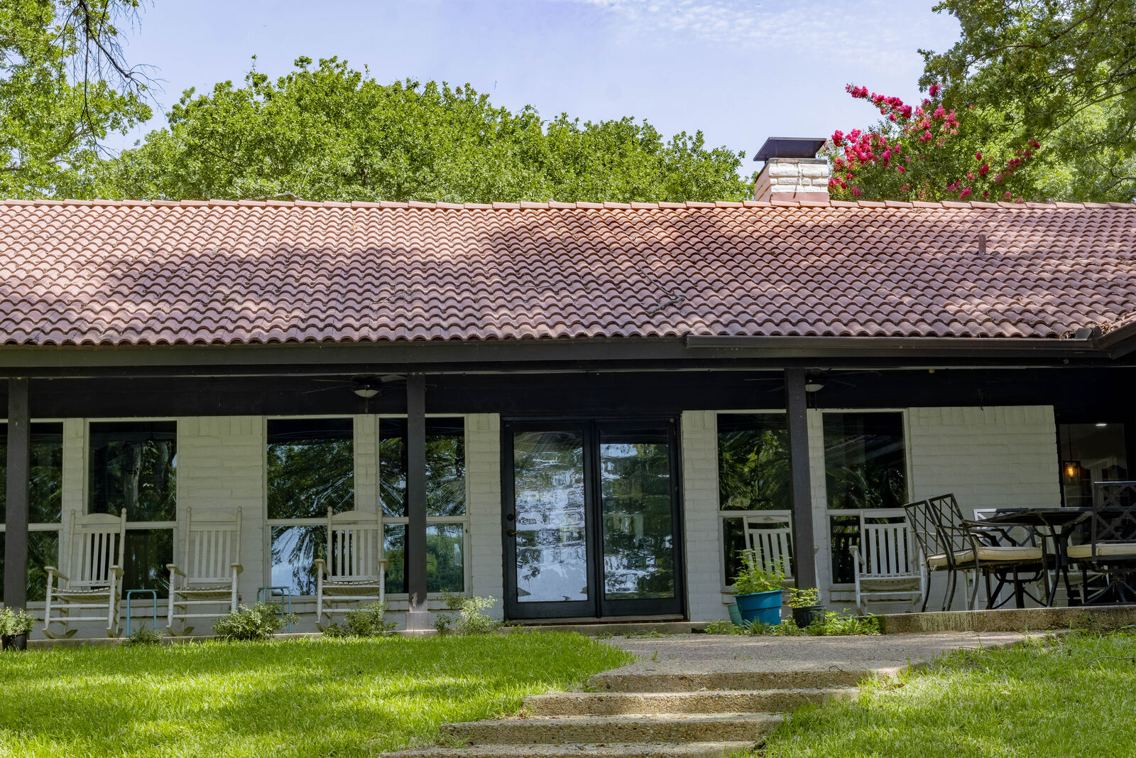 The covered lakeside porch with rocking chairs