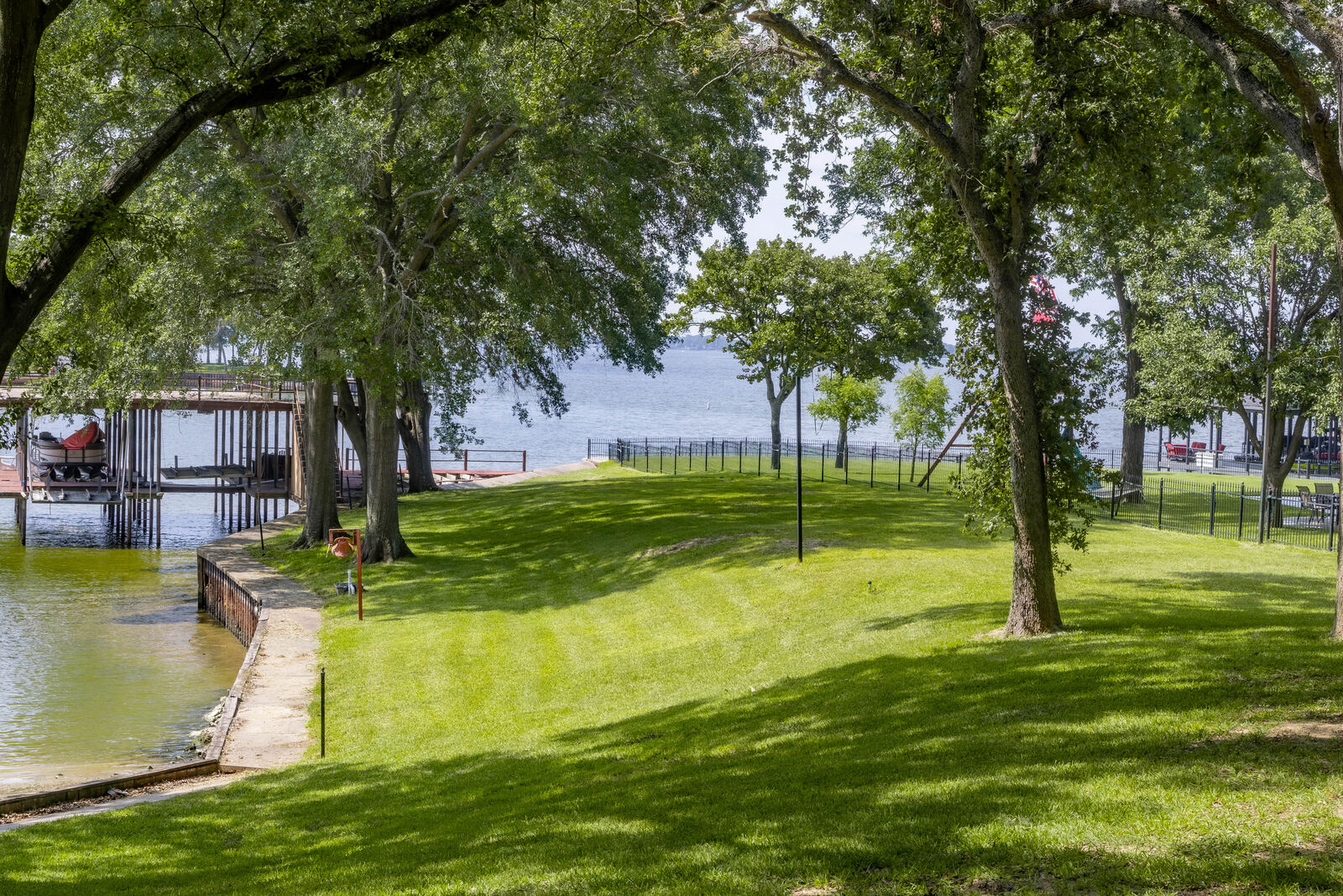 Open water beyond the fenced lawn